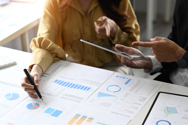 istock Two business people using digital tablet and discussing corporate business plan together. 1415534089