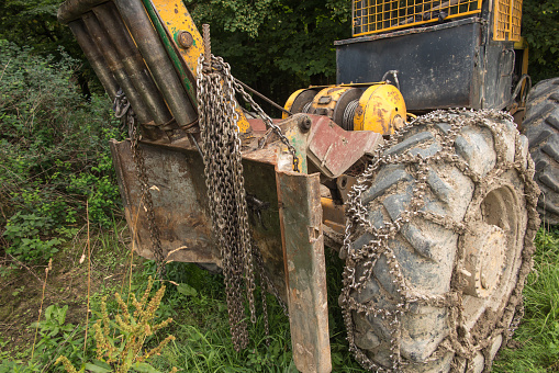 Chain on the wheels of a skidder, i.e. a tractor for skidding wood in difficult mountain terrain and with earthen ground