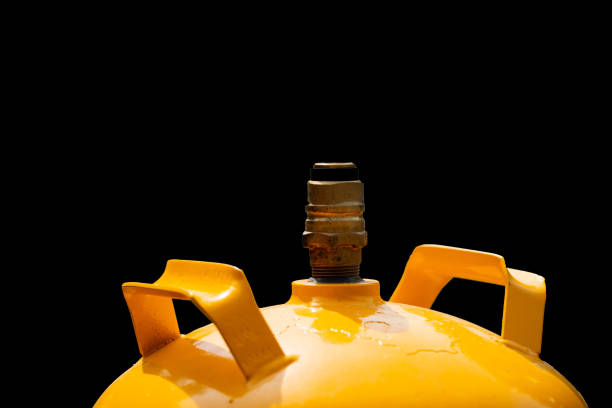 Valve or regulator on a Propane Gas Canister isolated on black background.