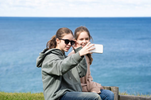 istock Two girls taking selfie on the seaside 1415538371