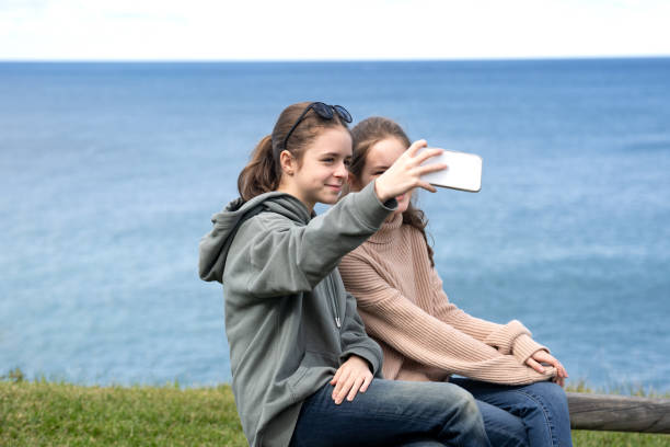 istock Two girls taking selfie on the seaside 1415538384