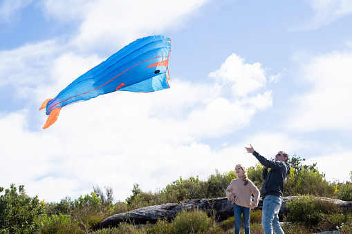 Father and daughter celebrating Father's day by flying a kite