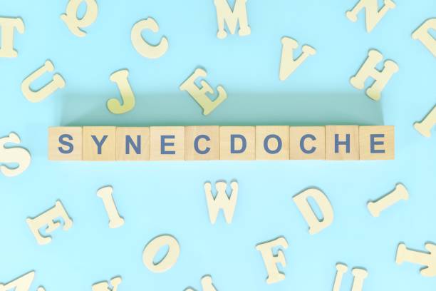 istock Synecdoche figure of speech figurative language concept in English grammar class lesson. Wooden blocks typography flat lay in blue background. 1415538464