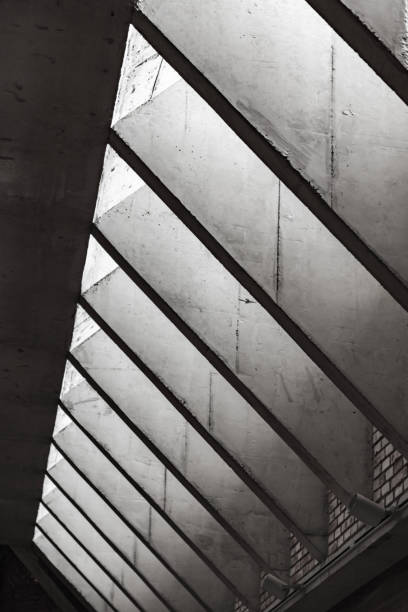 istock A row of sloping skylights that let in sunlight 1415541537