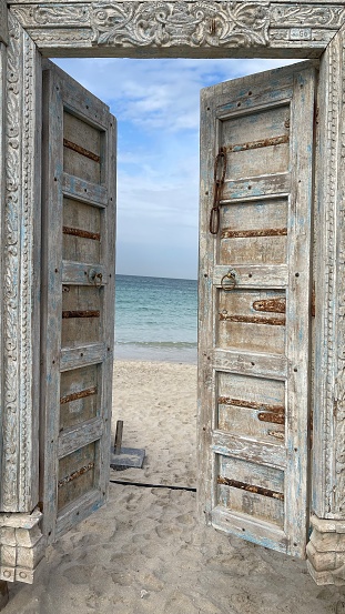 Wooden Door open to the beach