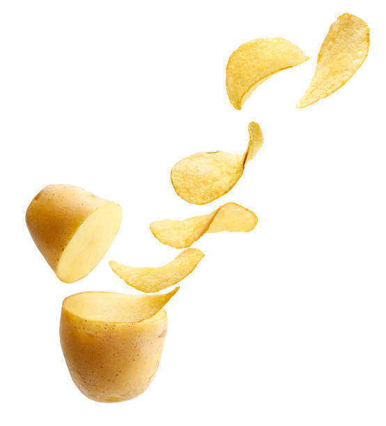Cut potato turning into potato chips isolated on white stock photo