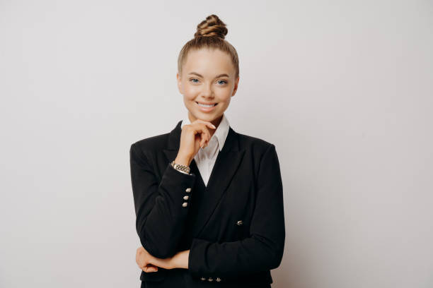 istock Happy female office worker with hand on chin 1415547905