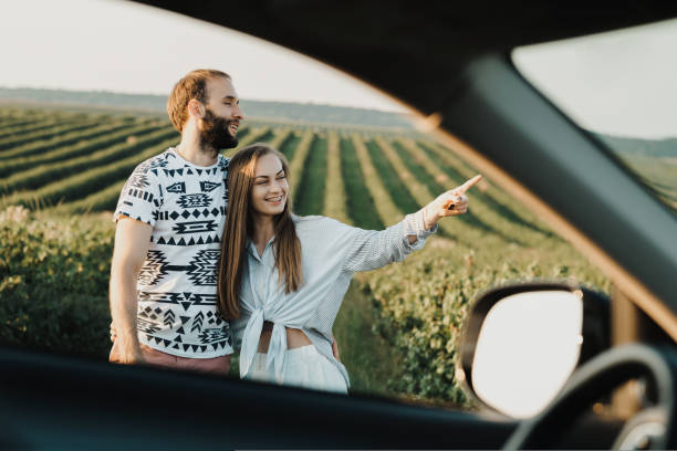 istock View through car window, happy middle-aged couple hugging together in the beautiful fields, caucasian man and woman enjoying vacation outdoors 1415550780