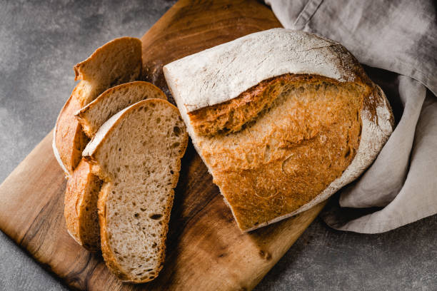 istock Sliced loaf of bread on cutting board. 1415553265