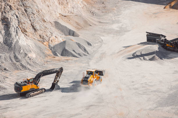 Dust flying in the air after the driving dump truck in the quarry stock photo