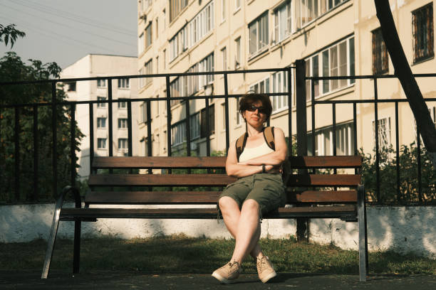 istock Active mature woman is sitting on bench 1415553692