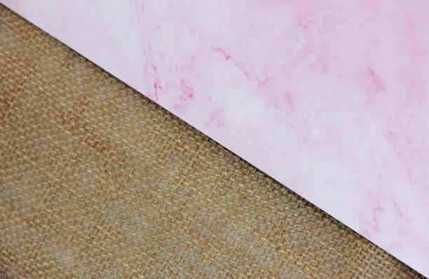 istock brown canvas fabric and marble pink background, divided diagonally 1415553984