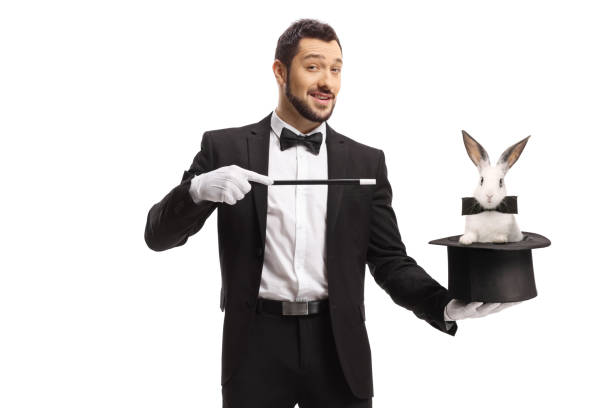 Magician performing a trick with a hat and a rabbit stock photo