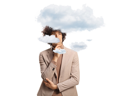 Young pensive man with a clouds around his head isolated on white background