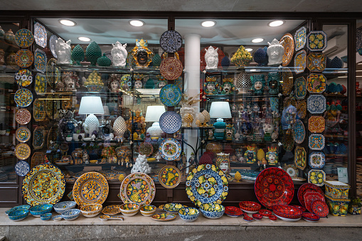 Taormina, Italy - July 10, 2022: Traditional Italian ceramic plates and bowls.