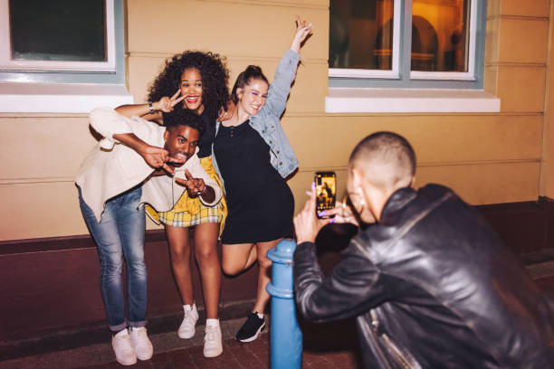 istock Gen z friends posing for a photo at night 1415558037