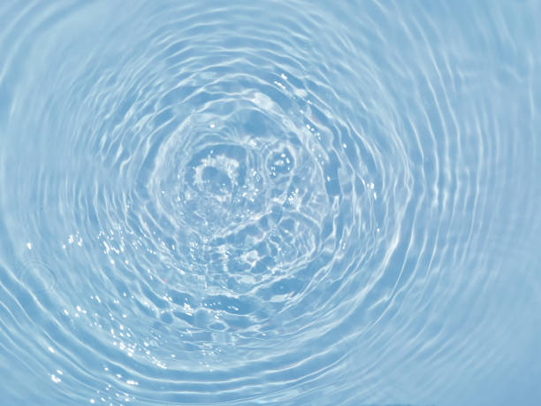 istock Defocus blurred transparent blue colored clear calm water surface texture with splashes and bubbles. Trendy abstract nature background. Water waves in sunlight. Blue water background. 1415559805