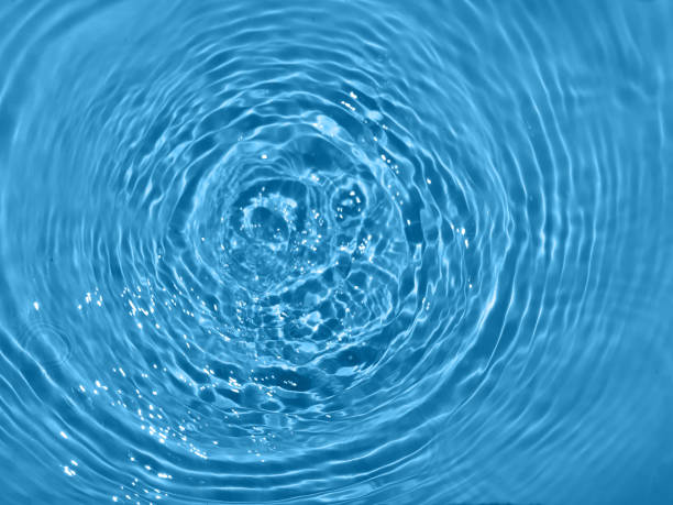 istock Defocus blurred transparent blue colored clear calm water surface texture with splashes and bubbles. Trendy abstract nature background. Water waves in sunlight. Blue water background. 1415560021