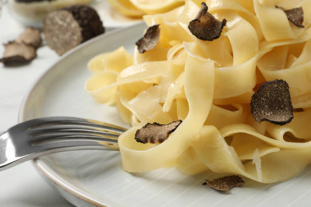 istock Delicious pasta with truffle slices served on white table, closeup 1415560069