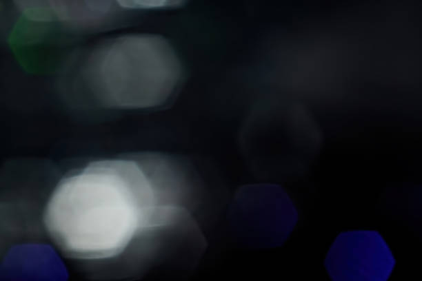 istock White and blue blurred bokeh on a black background. Defocused lights with copy space. 1415562808