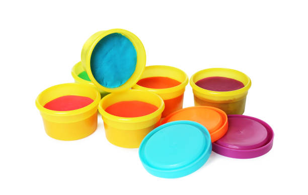 istock Plastic containers with colorful play dough on white background 1415563518