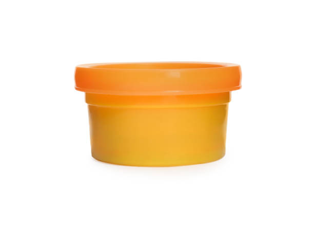 istock Plastic container of colorful play dough isolated on white 1415563620