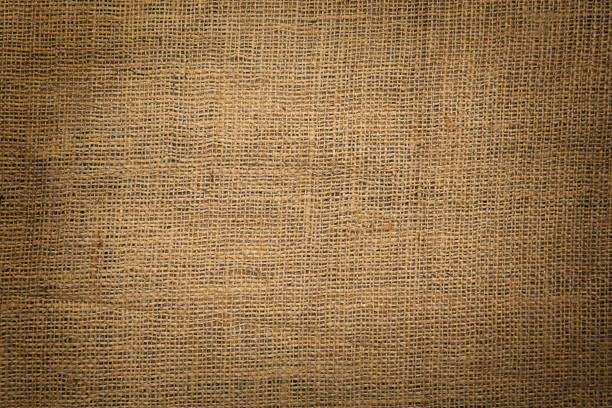 istock Texture of natural burlap fabric as background, top view. Vignette effect 1415565846