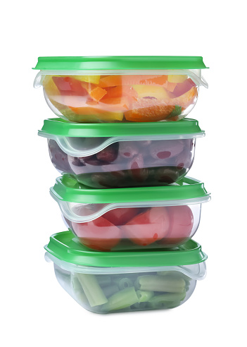 Fresh vegetables in plastic containers on white background