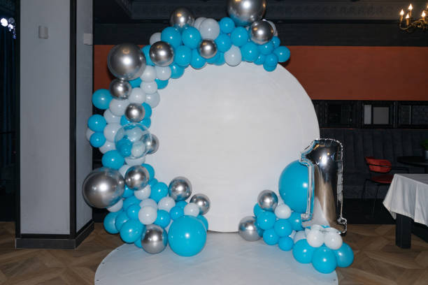 White round photo booth with blue and white balloons for first birthday stock photo