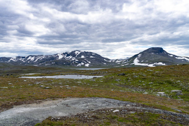 istock Small lakes and snow patched mountains in Norway 1415568491