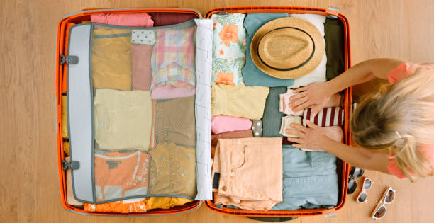 istock Woman packing clothes 1415570095