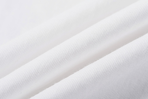 white cotton fabric texture background. Creases of cloth and cotton.