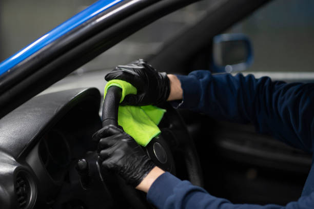 istock cleaning steering wheel, car detailing studio 1415571320