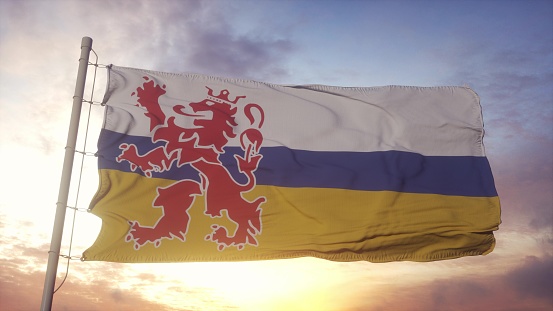 Limburg flag, Netherlands, waving in the wind, sky and sun background. 3d illustration.