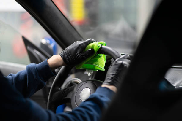 istock cleaning steering wheel, car detailing studio 1415571329