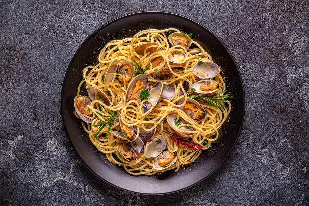 istock Seafood pasta with clams Spaghetti alle Vongole on a light background. Top view 1415571904