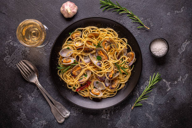 istock Seafood pasta with clams Spaghetti alle Vongole on a light background. Top view 1415572006