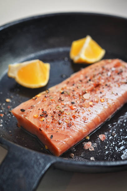 istock Salmon Fillet Steak In A Pan With Lemon Slices 1415574389