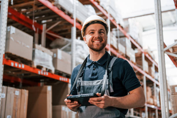 istock With digital tablet in hands. Employee in uniform is working in the storage at daytime 1415574556