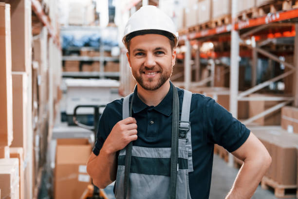 istock Standing and posing. Employee in uniform is working in the storage at daytime 1415574608
