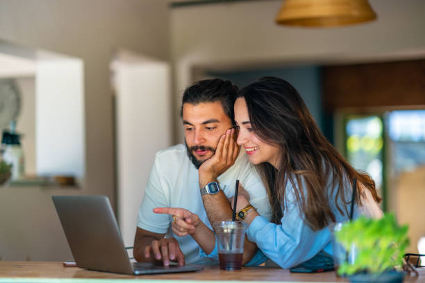 Young couple using laptop in a coffee shop
