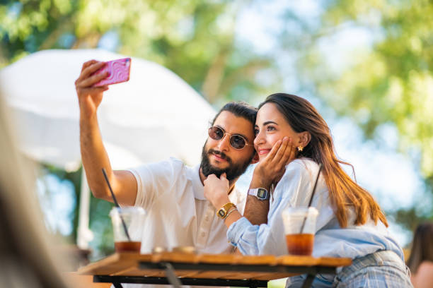 istock Young couple taking selfie at coffee shop 1415577914