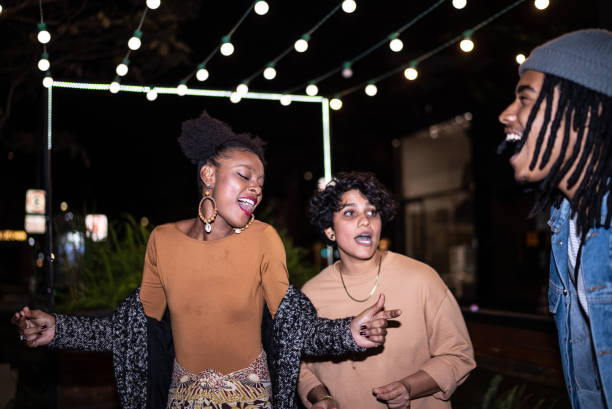 istock Group of young people having fun at night 1415578726