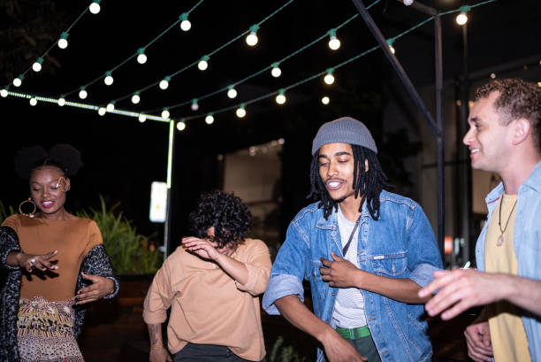 istock Group of young people having fun at night 1415578729