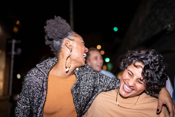 Happy lesbian couple having fun at night