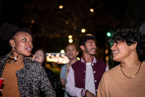 istock Friends having fun outdoors at night 1415578784