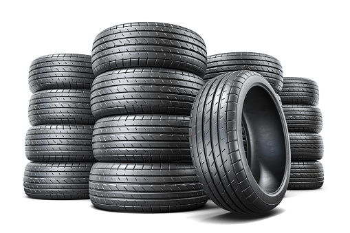 Warehouse with new car tires. Pile of tires isolated on white background. 3D render