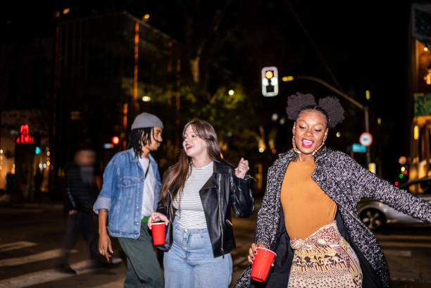 istock Group of friends dancing outside at night 1415579505