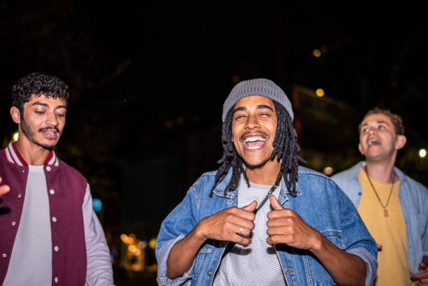 istock Group of friends dancing outside at night 1415579541