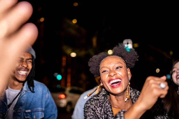 istock Group of friends dancing outside at night 1415579542